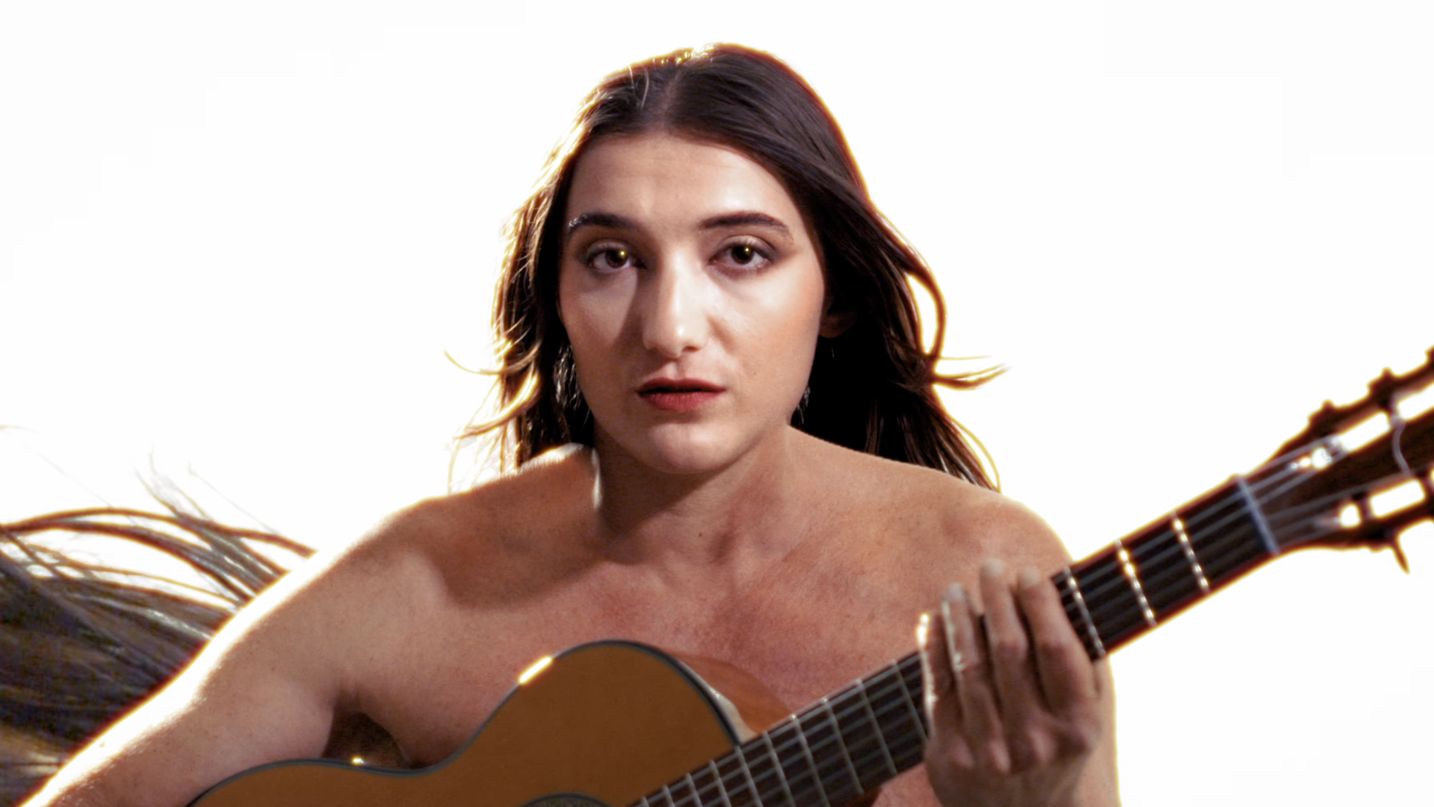 Video thumbnail : a woman's head on an old man's body, holding a guitar.